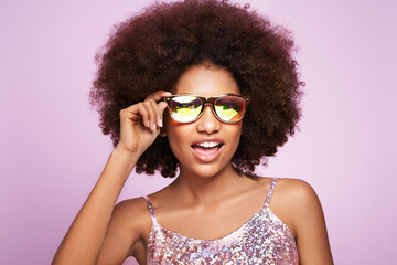 Beauty portrait of African American girl in colored holographic sunglasses. Beautiful black woman...