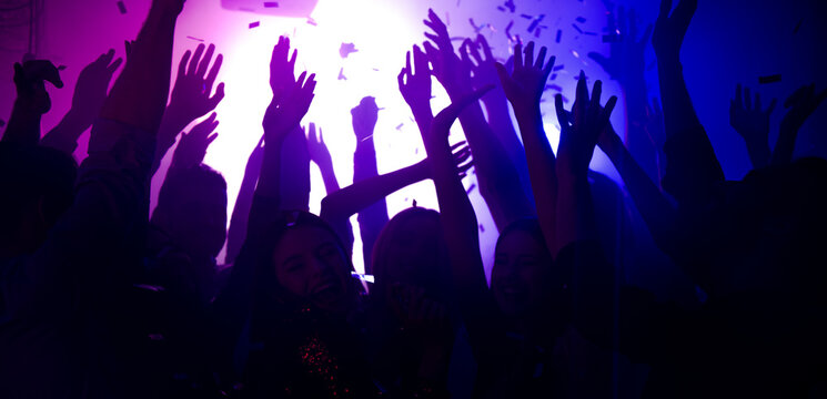 Photo of carefree bachelors clubbers fellows enjoy nightlife dj rock band show raise hands up on bright filter festival soft focus