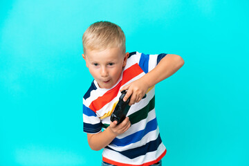 Little Russian boy playing with a video game controller over isolated background © luismolinero