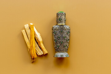 Agar wood tree oil perfume in silver bottle with sticks of tree