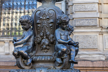 Details of decorations of street lamps at the Stieglitz Academy in St. Petersburg in the form of seated putto