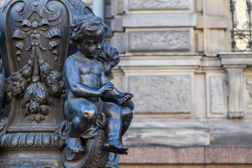 An architectural element in the form of a putty at the base of a street lamp at the Stieglitz School in St. Petersburg