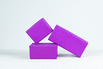 Three boxes wrapped in a gift paper on white table Velvet violet