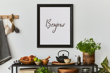 Stylish and cozy kitchen interior composition with mock up poster frame,black console, teapot, plants and retro inspired accessories. Template. Autumn vibes..