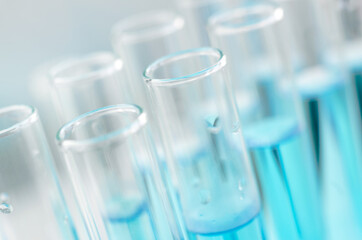 Scientific laboratory research and experiments. Laboratory test tubes with blue liquid close-up, selective focus.
