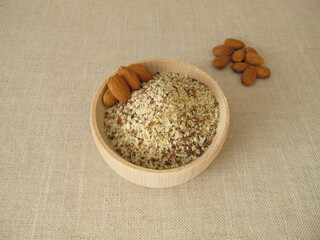 Unpeeled ground almonds in a wooden bowl