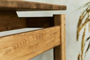 Creative close up composition of elegant wooden dining table. Beautiful home decorations and accessories. Modern home interior design. Wabi-sabi inspiration. Template..