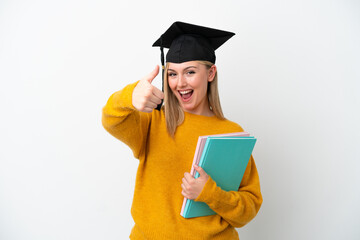 Young student caucasian woman isolated on white background with thumbs up because something good has happened