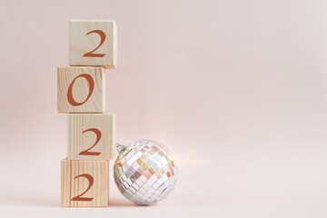 Wooden cubes pyramid with new year numbers and shining disco ball