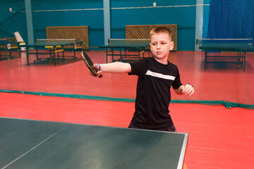 the child plays table tennis professionally. children's training in table tennis. Shock testing