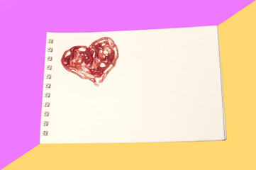 Notebook with heart isolated on color background.Copy space