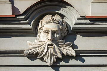 Relief on facade of an old building, mascaron ornament in Vilnius, Lithuania