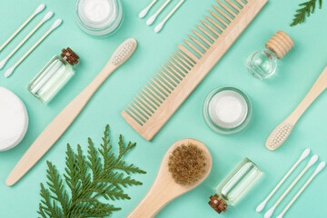 Fototapeta na wymiar Organic cosmetics for skin care. Cotton swabs, face cream, wooden comb, face serum, essential oil, toothbrush. Zero waste concept. View from above.