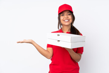 Young Pizza delivery girl over isolated white background holding copyspace imaginary on the palm to...