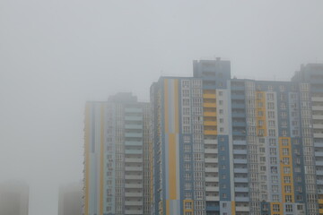 high-rise buildings in dense fog