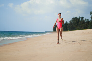 Healthy lifestyle. Jogging outdoors. Young woman exercising on sea beach.