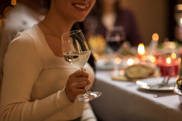 holidays, party and celebration concept - close up of happy smiling woman having christmas dinner...