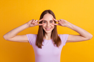 Photo of youth lady have fun show fingers peace victory v-symbol isolated over yellow color background