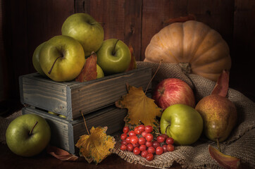 Apples and other foods on a dark wooden background