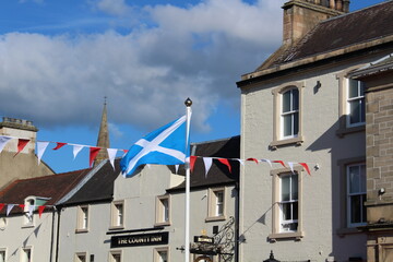 Fototapeta na wymiar Scottish flag in Peebles during Beltane festival.