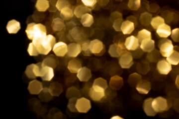Golden blurred bokeh lights on black background. Glitter sparkle stars for celebrate. Overlay for your design