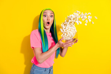 Photo of scared afraid young vibrant woman wear pink t-shirt throwing popcorn watching horror isolated yellow color background