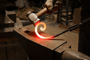 Close up view of heated metal and anvil. The blacksmith in the production process of metal products...