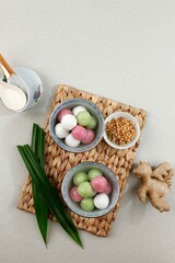 Tang Yuan (Wedang Ronde), Chinese Glutinous Rice Dumpling Balls with Sugar Ginger Syrup on Red Chinese on Red  Background for Winter Solstice New Year or Lantern Festival Food