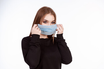 Young girl in a protective mask from the virus on a white background