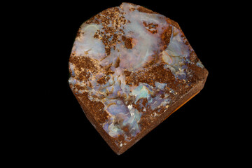 Macro stone Opal mineral in rock on a black background close up