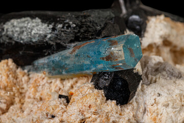 Macro stone mineral tourmaline aquamarine with a black background