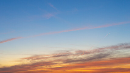 Beautiful Vivid sky painted by the sun leaving bright golden shades.Dense clouds in twilight sky in winter evening.Image of cloud sky on evening time.Evening Vivid sky with clouds.