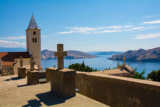 St John the Baptist Church and cemetrey, on a hill overlooking Baska town on Krk island, Primorje-Gorski Kotar County. Also called Crkva Svetog Ivana. The island in the background is Otok Prvic
