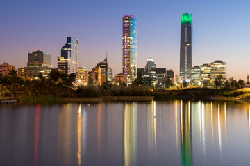 Obraz premium Pond at Bicentennial Park in the wealthy Vitacura district and skyline of buildings at financial district, Santiago de Chile