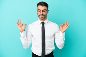 Business caucasian man isolated on blue background in zen pose