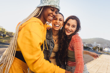 Young friends laughing together outdoors