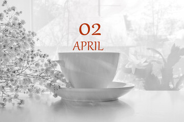 calendar date on light background with porcelain white tea pair and white gypsophila with copy...