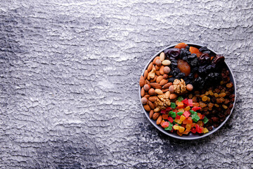 Dried fruits and nuts on a gray background with place for text. Top view