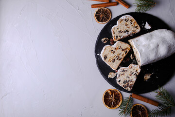 Dresdner Stollen is a Traditional German Cake with raisins on grey background with place for text. Fruit cake for the Holiday.