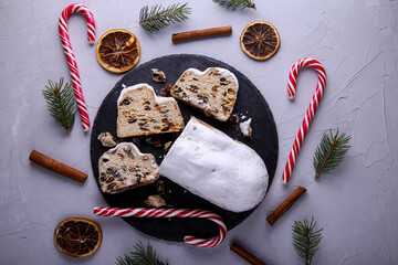 Dresdner Stollen is a Traditional German Cake with raisins on grey background. Fruit cake for the Holiday.