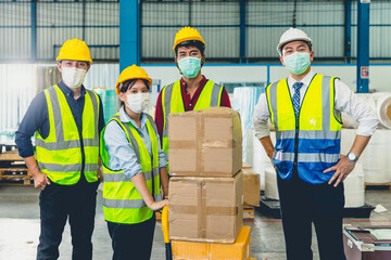Group of team Asian worker wear face mask standing together in store warehouse