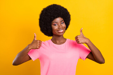 Photo of young african girl happy positive smile show thumbs-up fine suggest ad isolated over yellow color background