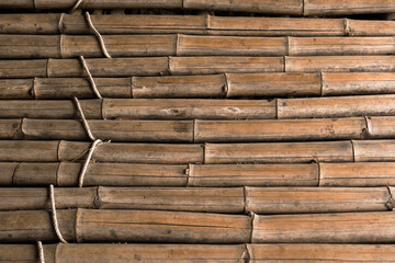 Old brown tone bamboo simple floor or Bamboo texture background for interior or exterior design vintage tone. Brown bamboo stick pattern backdrop. The walkway is made of bamboo bundles.