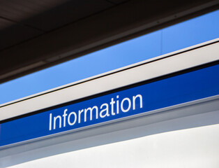 Word Information on blue sign. Information desk. Information board in airport. Direction sign at railroad station. Public transportation concept. Travel and tourism concept. 
