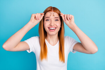 Fototapeta premium Photo of young girl happy positive smile excited surprised news hands touch glasses isolated over blue color background