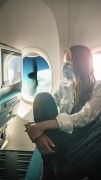 A young woman wearing face mask during travel with airplane , New normal journey after covid-19 pandemic concept. Cinemagraph. Still picture with moving propeller