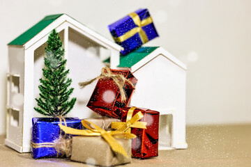 Countdown timer for Christmas, New Year and Boxing day concept. Present boxes, shopping cart, pine tree, house models and sand running through hourglass on light brown background.