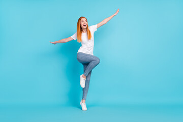 Fototapeta na wymiar Full length photo of young girl happy positive smile playful hands wings look empty space isolated over blue color background