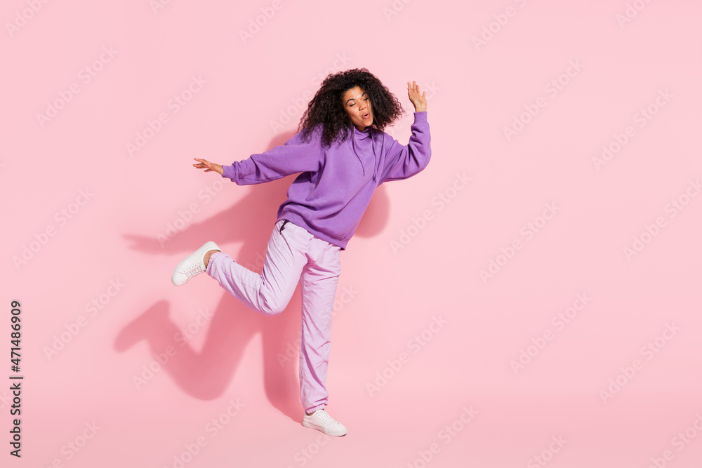 Sticker photo of adorable pretty african lady dressed purple hoodie smiling dancing empty space isolated pin