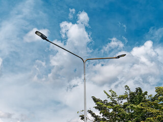 Low Angle View of Street Lamps Post Against Blue Cloudy Sky